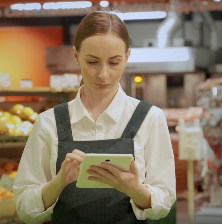 woman using ipad in grocery store